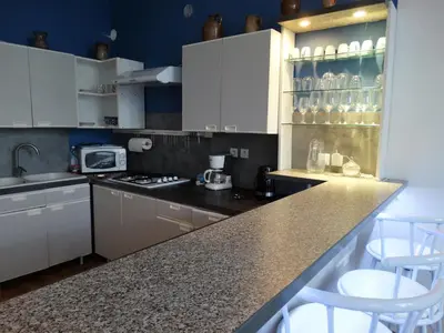 Cuisine ou kitchenette dans l'établissement Location courte durée
