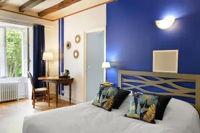 Un ou plusieurs lits dans un hébergement de l'établissement Logis Manoir De La Giraudière