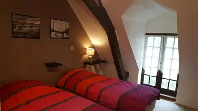 Un ou plusieurs lits dans un hébergement de l'établissement GITE LONGERE DE 15 PERSONNES AU CHATEAU DE JALLANGES VOUVRAY