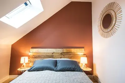 Un ou plusieurs lits dans un hébergement de l'établissement L'Atypique, charmante maison avec jardin clos
