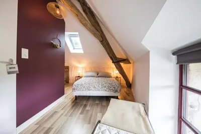 Un ou plusieurs lits dans un hébergement de l'établissement L'Atypique, charmante maison avec jardin clos