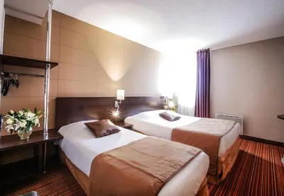 Un ou plusieurs lits dans un hébergement de l'établissement Hôtel Inn Design & Restaurant Le Mans