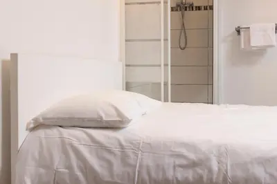 Un ou plusieurs lits dans un hébergement de l'établissement Hôtel Du Bellay