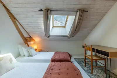 Un ou plusieurs lits dans un hébergement de l'établissement Loft de La Maison des Chalands