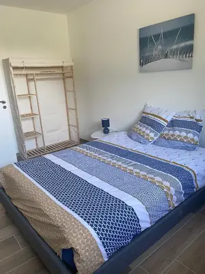 Un ou plusieurs lits dans un hébergement de l'établissement Maison Grands Espaces Calme Jardin/Bois proche 24h du Mans