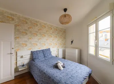 Un ou plusieurs lits dans un hébergement de l'établissement Appartement Cosy avec garage privé