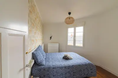 Un ou plusieurs lits dans un hébergement de l'établissement Appartement Cosy avec garage privé