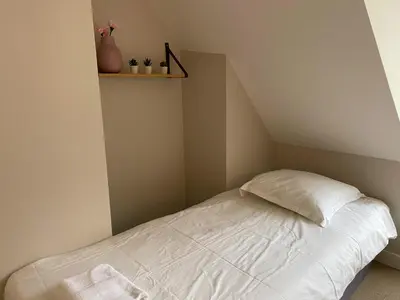 Un ou plusieurs lits dans un hébergement de l'établissement Maison des fleurs
