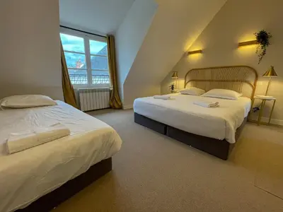 Un ou plusieurs lits dans un hébergement de l'établissement Maison des fleurs