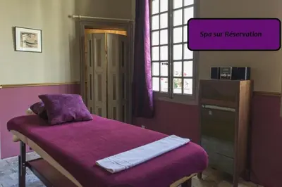 Un ou plusieurs lits dans un hébergement de l'établissement Le Patio & Spa