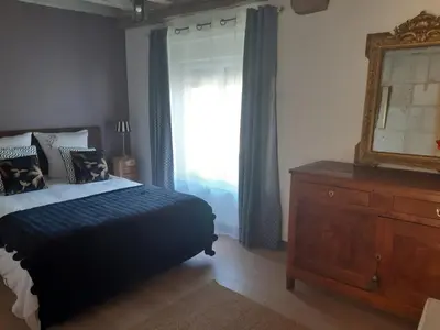 Un ou plusieurs lits dans un hébergement de l'établissement Agréables chambres d'hôtes dans maison XVIIIe