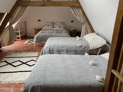 Un ou plusieurs lits dans un hébergement de l'établissement Gîte de charme 