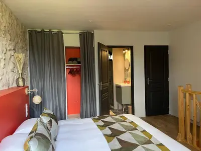 Un ou plusieurs lits dans un hébergement de l'établissement Le Moulin de Moquesouris - Chambres d'hôtes et table d'hôte