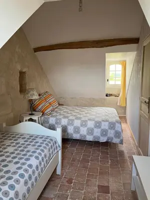 Un ou plusieurs lits dans un hébergement de l'établissement Chambres d’hôtes en campagne