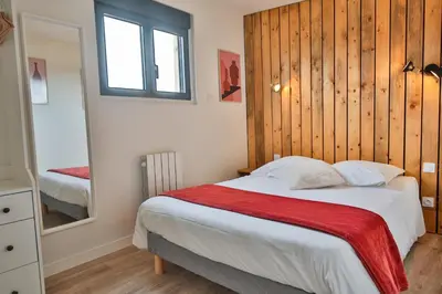 Un ou plusieurs lits dans un hébergement de l'établissement Chalet Vintage Les Belles Ouvrières