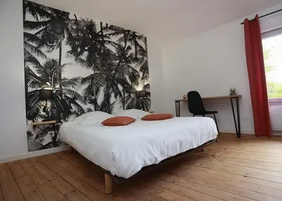 Un ou plusieurs lits dans un hébergement de l'établissement Maison Le Lodge- Centre Doué la Fontaine proche zoo