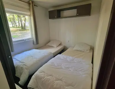 Un ou plusieurs lits dans un hébergement de l'établissement Camping les petites minaudières
