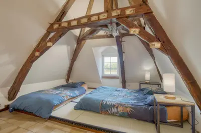 Un ou plusieurs lits dans un hébergement de l'établissement Jacuzzi et Vue sur Loire - Maison d'hôtes L'Odyssée