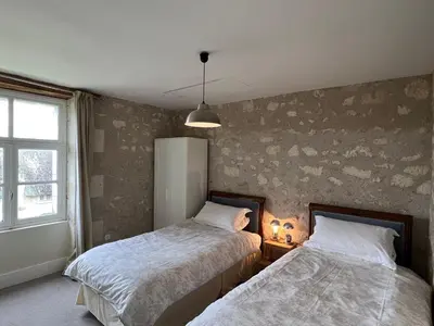 Un ou plusieurs lits dans un hébergement de l'établissement Gîtes du château de La Celle-Guenand